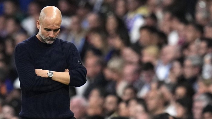 Spain Soccer Champions League Manchester Citys head coach Pep Guardiola grimaces during the Champions League playoff second leg soccer match between Real Madrid and Manchester City at the Santiago Bernabeu Stadium in Madrid, Spain, Wednesday, Feb. 19, 2025. (AP Photo/Manu Fernandez)