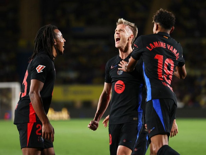 LAS PALMAS, SPAIN - FEBRUARY 22: Dani Olmo of FC Barcelona celebrates with his team mates Jules Kounde and Lamine Yamal after scoring his teams first goal during the LaLiga match between UD Las Palmas and FC Barcelona at Estadio Gran Canaria on February 22, 2025 in Las Palmas, Spain. (Photo by Florencia Tan Jun/Getty Images)