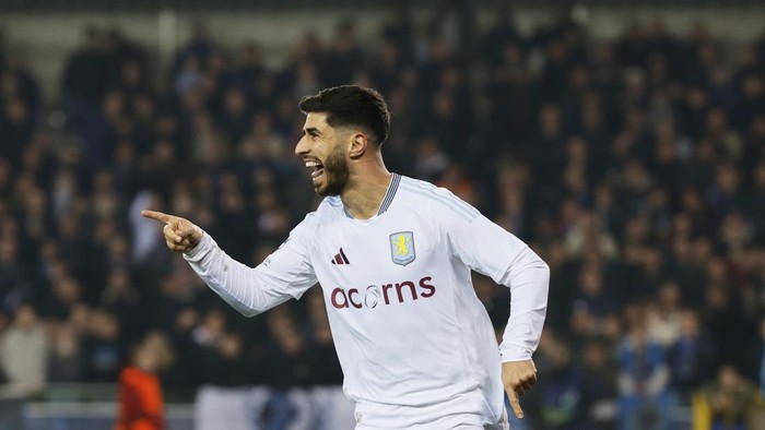 Aston Villas Marco Asensio celebrates after an own goal by Brugges Brandon Mechele made it past Brugges goalkeeper Simon Mignolet during the Champions League round of 16 first leg soccer match between Club Brugge and Aston Villa at the Jan Breydel Stadium in Bruges, Belgium, Tuesday, March 4, 2025. (AP Photo/Geert Vanden Wijngaert)