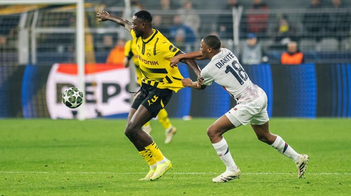 DORTMUND, GERMANY - MARCH 04: Serhou Guirassy of Borussia Dortmund is in action against Bafode Diakite during the UEFA Champions League 2024/25 UEFA Champions League 2024/25 Round of 16 first leg match between Borussia Dortmund and LOSC Lille at BVB Stadion Dortmund on March 04, 2025 in Dortmund, Germany. (Photo by Hesham Elsherif/Anadolu via Getty Images)
