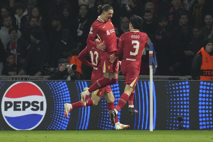 Liverpools Darwin Nunez, left, and Liverpools Wataru Endo celebrate after a goal during the Champions League round of 16 first leg soccer match betwen Paris Saint-Germain and Liverpool in Paris, France, Wednesday, March 5, 2025. (AP Photo/Christophe Ena)