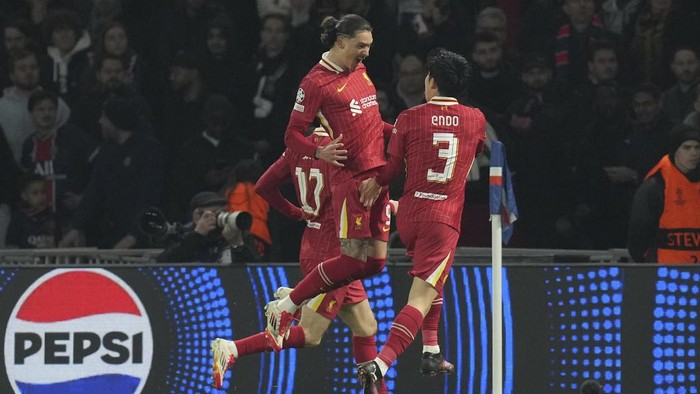 Liverpools Darwin Nunez, left, and Liverpools Wataru Endo celebrate after a goal during the Champions League round of 16 first leg soccer match betwen Paris Saint-Germain and Liverpool in Paris, France, Wednesday, March 5, 2025. (AP Photo/Christophe Ena)