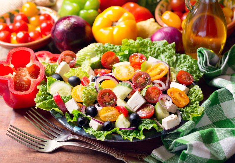 plate of greek salad on wooden table
