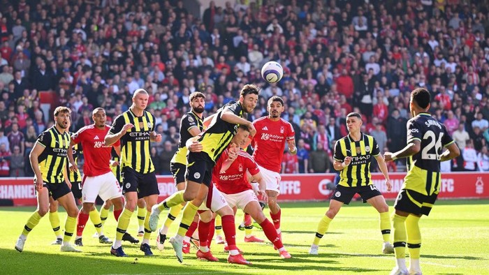 NOTTINGHAM, ENGLAND - MARCH 08: Nico Gonzalez of Manchester City clears the ball under pressure from Elliot Anderson of Nottingham Forest during the Premier League match between Nottingham Forest FC and Manchester City FC at the City Ground on March 08, 2025 in Nottingham, England. (Photo by Michael Regan/Getty Images)