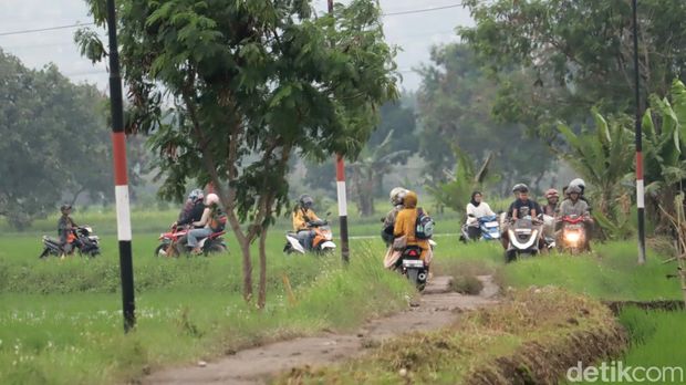 Pemotor tinggalkan pematang sawah alasannya banjir di wilayah Sapan, Bojongsoang, Kabupaten Bandung, Senin 10 Maret 2025