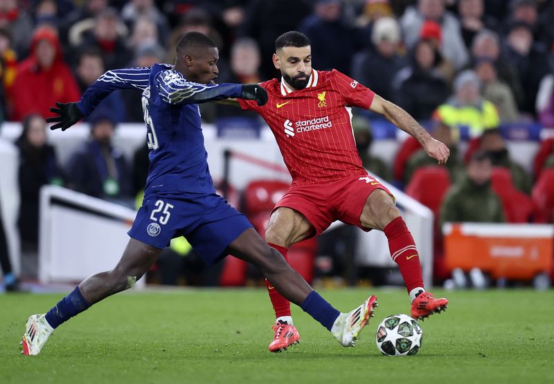  Nuno Mendes of Paris Saint-Germain and Mohamed Salah of Liverpool challenge during the UEFA Champions League 2024/25 UEFA Champions League 2024/25 Round of 16 Second Leg match between Liverpool FC and Paris Saint-Germain at Anfield on March 11, 2025 in Liverpool, England. (Photo by ed Sykes/Sportsphoto/Allstar via Getty Images)