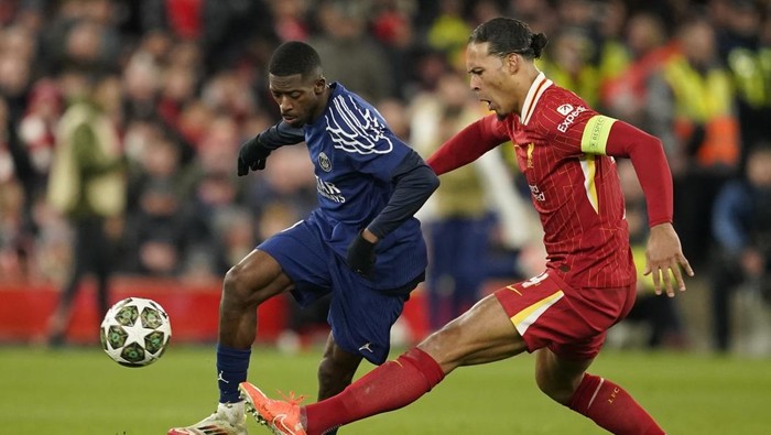 PSG, Liverpool Liverpools Virgil van Dijk, right, challenges PSGs Ousmane Dembele during the Champions League round of 16 second leg soccer match between Liverpool and Paris Saint-Germain at Anfield in Liverpool, England, Tuesday, March 11, 2025. (AP Photo/Dave Thompson)