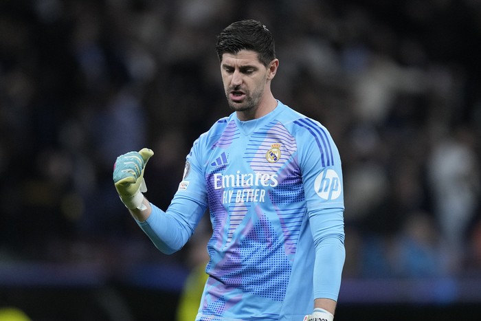 Real Madrid's goalkeeper Thibaut Courtois celebrates the third goal of his team during the Champions League playoff second leg soccer match between Real Madrid and Manchester City at the Santiago Bernabeu Stadium in Madrid, Spain, Wednesday, Feb. 19, 2025. (AP Photo/Bernat Armangue)