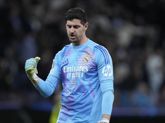 Real Madrids goalkeeper Thibaut Courtois celebrates the third goal of his team during the Champions League playoff second leg soccer match between Real Madrid and Manchester City at the Santiago Bernabeu Stadium in Madrid, Spain, Wednesday, Feb. 19, 2025. (AP Photo/Bernat Armangue)