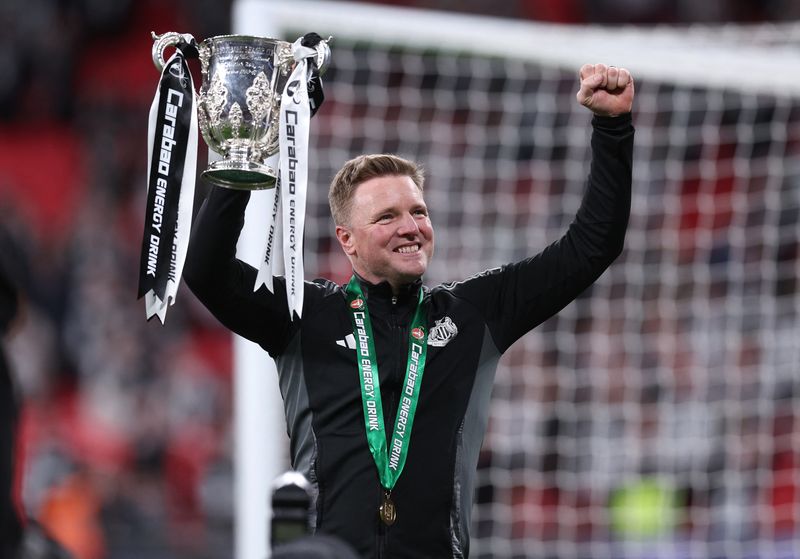 Soccer Football - Carabao Cup - Final - Liverpool v Newcastle United - Wembley Stadium, London, Britain - March 16, 2025 Newcastle United manager Eddie Howe celebrates with the trophy after winning the Carabao Cup REUTERS/Dylan Martinez EDITORIAL USE ONLY. NO USE WITH UNAUTHORIZED AUDIO, VIDEO, DATA, FIXTURE LISTS, CLUB/LEAGUE LOGOS OR 'LIVE' SERVICES. ONLINE IN-MATCH USE LIMITED TO 120 IMAGES, NO VIDEO EMULATION. NO USE IN BETTING, GAMES OR SINGLE CLUB/LEAGUE/PLAYER PUBLICATIONS. PLEASE CONTACT YOUR ACCOUNT REPRESENTATIVE FOR FURTHER DETAILS..