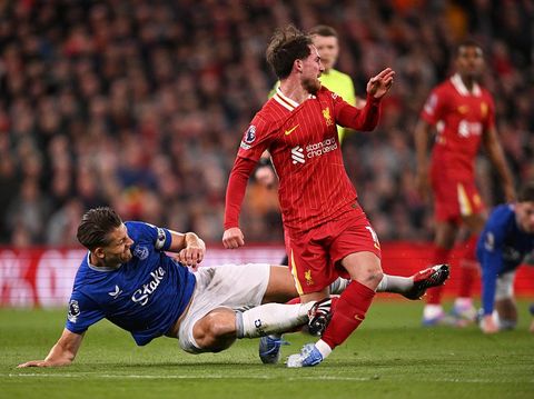 LIVERPOOL, ENGLAND - APRIL 02: (THE SUN OUT, THE SUN ON SUNDAY OUT) Alexis Mac Allister of Liverpool is fouled by James Tarkowski of Everton during the Premier League match between Liverpool FC and Everton FC at Anfield on April 02, 2025 in Liverpool, England. (Photo by Liverpool FC/Liverpool FC via Getty Images)