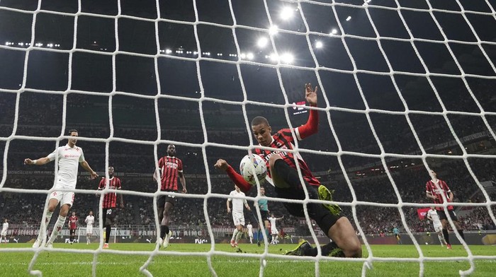 AC Milans Malick Thiaw scores an own goal during the Italian Serie A soccer match between AC Milan and Fiorentina at the San Siro Stadium in Milan, Italy, Saturday, April 5, 2025. (AP Photo/Antonio Calanni)