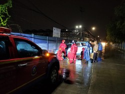 Damkar Jakut Evakuasi Taksi Terperosok ke Selokan