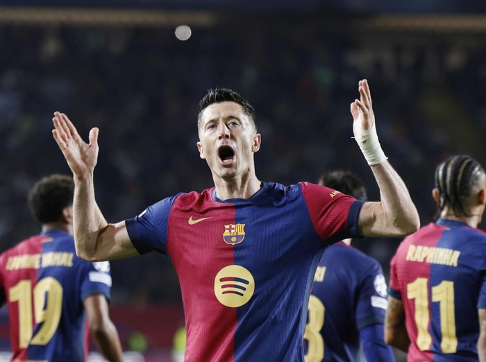 Barcelona's Robert Lewandowski celebrates after scoring his side's third goal during the Champions League quarterfinals first leg soccer match between Barcelona and Borussia Dortmund, at the Lluis Companys Olympic stadium in Barcelona, Spain, Wednesday, April 9, 2025. (AP Photo/Joan Monfort)