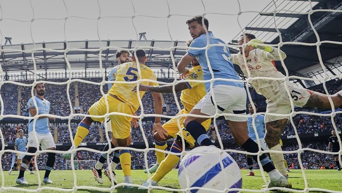 Manchester Citys Ruben Dias, center right, reacts asCrystal Palaces Chris Richards scores his sides second goal during the English Premier League soccer match between Manchester City and Crystal Palace at the Etihad stadium in Manchester, England, Saturday, April 12, 2025. (Martin Rickett/PA via AP)