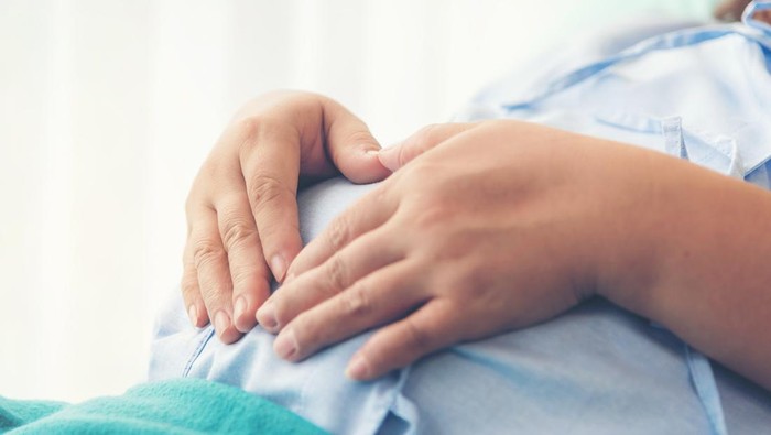 Pregnant woman lying on the bed waiting to give birth in a hospital.