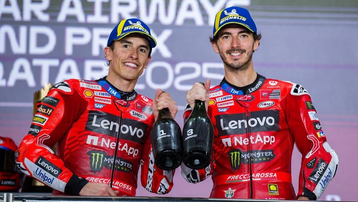 Spanish MotoGP rider Marc Marquez of the Ducati Lenovo Team, who wins, and Italian MotoGP rider Francesco Bagnaia of the Ducati Lenovo Team, who places third, celebrate on the podium with a trophy after the MotoGP final race during the Qatar Airways Motorcycle Grand Prix of Qatar at Lusail International Circuit in Lusail, Qatar, on April 13, 2025. (Photo by Noushad Thekkayil/NurPhoto via Getty Images)