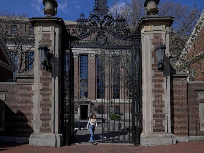 A woman walks on the campus of Harvard University in Cambridge, Massachusetts, U.S., April 15, 2025. REUTERS/Faith Ninivaggi Purchase Licensing Rights Trump