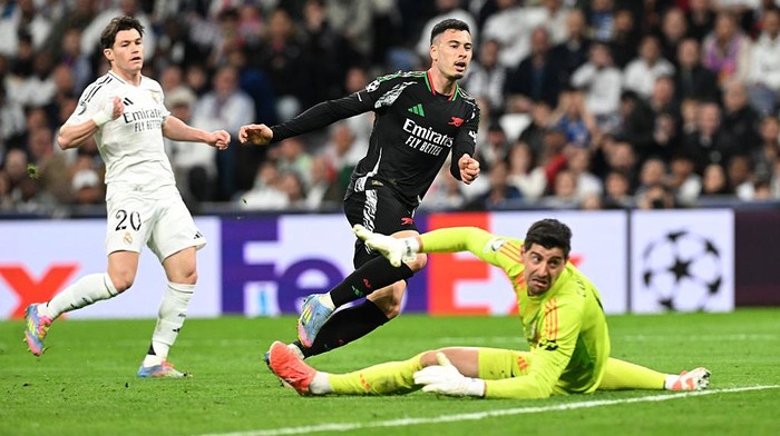 MADRID, SPAIN - APRIL 16: Gabriel Martinelli of Arsenal looks on after scoring his team's second goal past Thibaut Courtois of Real Madrid  during the UEFA Champions League 2024/25 Quarter Final Second Leg match between Real Madrid C.F. and Arsenal FC at Estadio Santiago Bernabeu on April 16, 2025 in Madrid, Spain. (Photo by Stuart MacFarlane/Arsenal FC via Getty Images)