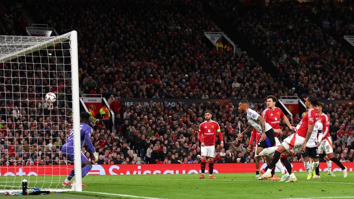 MANCHESTER, ENGLAND - APRIL 17: Corentin Tolisso of Olympique Lyonnais scores his teams first goal during the UEFA Europa League 2024/25 Quarter Final Second Leg match between Manchester United and Olympique Lyonnais at Old Trafford on April 17, 2025 in Manchester, England. (Photo by Molly Darlington/Copa/Getty Images)