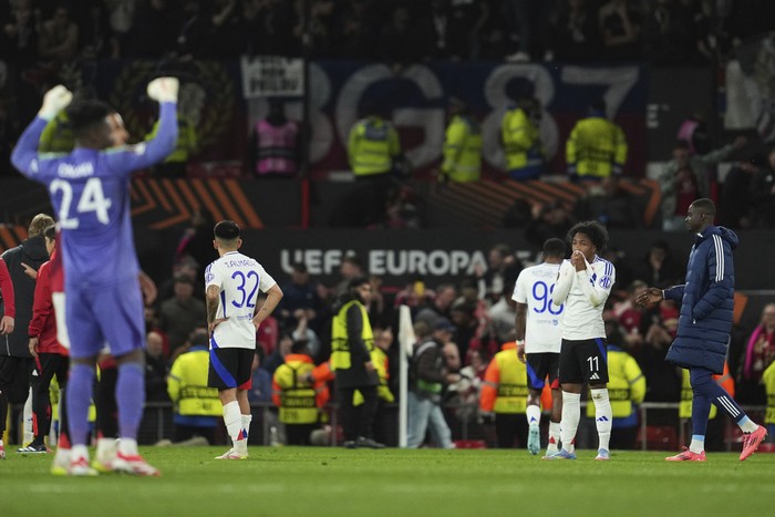 Lyons Malick Fofana, right, reacts after the Europa League quarter final second leg soccer match between Manchester United and Olympique Lyon in Manchester, Britain, Thursday, April 17, 2025. (AP Photo/Jon Super)
