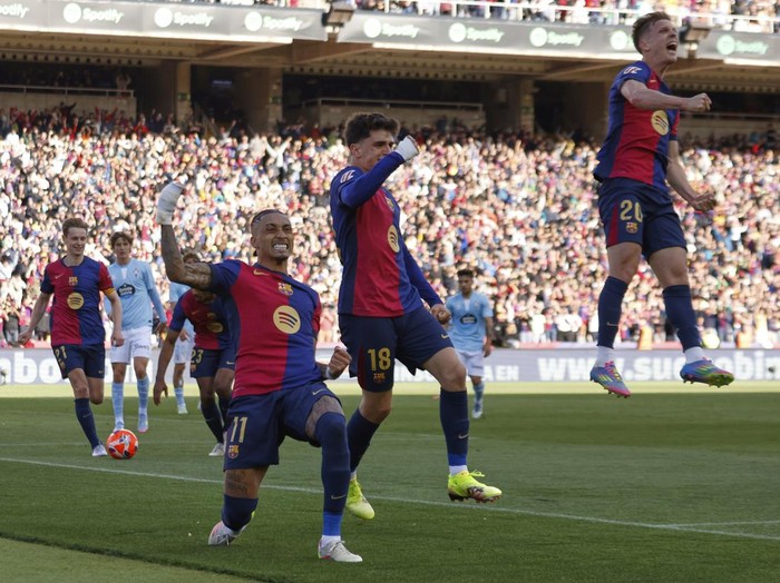 Barcelona's Raphinha, centre left, celebrates with teammates after scoring his side's fourth goal during a Spanish La Liga soccer match between Barcelona and Celta de Vigo at the Lluis Companys Olympic stadium in Barcelona, Spain, Saturday, April 19, 2025. (AP Photo/Joan Monfort)