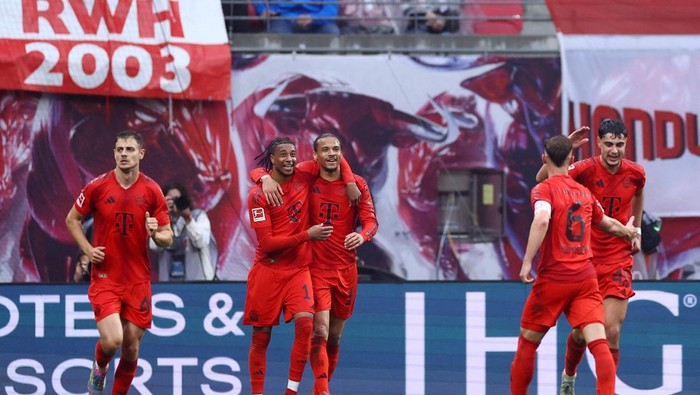 Bayern Munich Soccer Football - Bundesliga - RB Leipzig v Bayern Munich - Red Bull Arena, Leipzig, Germany - May 3, 2025 Bayern Munichs Leroy Sane celebrates scoring their third goal with Michael Olise REUTERS/Lisi Niesner DFL REGULATIONS PROHIBIT ANY USE OF PHOTOGRAPHS AS IMAGE SEQUENCES AND/OR QUASI-VIDEO.