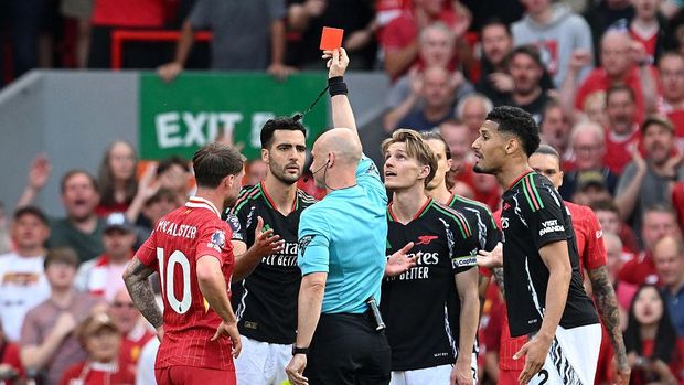 LIVERPOOL, ENGLAND - MAY 11: Mikel Merino of Arsenal receives a red card from referee Anthony Taylor during the Premier League match between Liverpool FC and Arsenal FC at Anfield on May 11, 2025 in Liverpool, England. (Photo by Stuart MacFarlane/Arsenal FC via Getty Images)