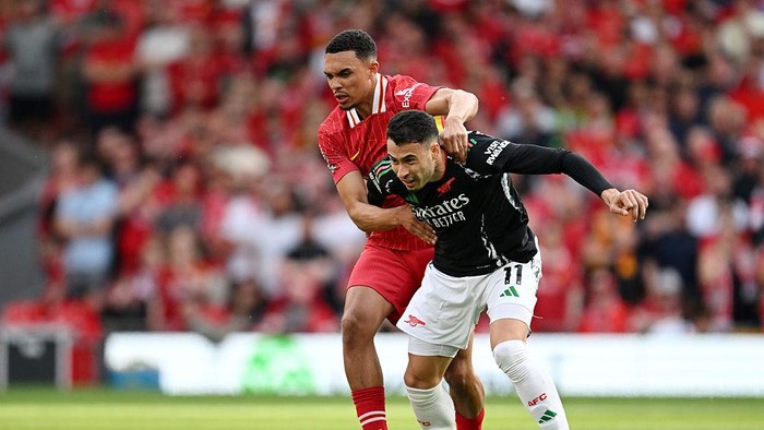 LIVERPOOL, ENGLAND - MAY 11: Gabriel Martinelli of Arsenal is challenged by Trent Alexander-Arnold of Liverpool during the Premier League match between Liverpool FC and Arsenal FC at Anfield on May 11, 2025 in Liverpool, England. (Photo by Stuart MacFarlane/Arsenal FC via Getty Images)
