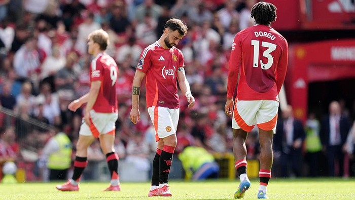 Manchester United Manchester Uniteds Bruno Fernandes (centre) stands dejected after the Premier League match at Old Trafford, Manchester. Picture date: Sunday May 11, 2025. (Photo by Martin Rickett/PA Images via Getty Images)