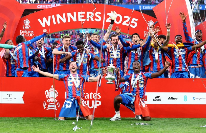 Soccer Football - FA Cup - Final - Crystal Palace v Manchester City - Wembley Stadium, London, Britain - May 17, 2025 Crystal Palace's Joel Ward and Marc Guehi with the trophy as they celebrate with teammates after winning the FA Cup Action Images via Reuters/Andrew Boyers