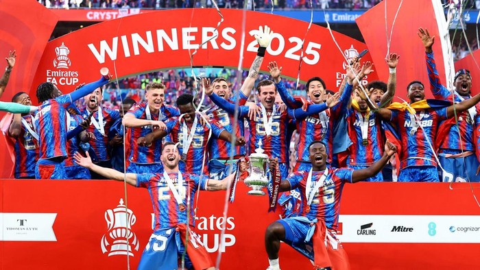 Soccer Football - FA Cup - Final - Crystal Palace v Manchester City - Wembley Stadium, London, Britain - May 17, 2025 Crystal Palace's Joel Ward and Marc Guehi with the trophy as they celebrate with teammates after winning the FA Cup Action Images via Reuters/Andrew Boyers