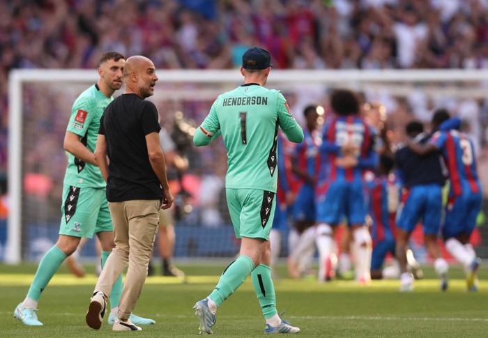 Soccer Football - FA Cup - Final - Crystal Palace v Manchester City - Wembley Stadium, London, Britain - May 17, 2025 Manchester City manager Pep Guardiola with Crystal Palaces Dean Henderson and teammates after Crystal Palace won the  FA Cup REUTERS/David Klein