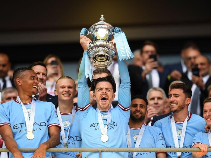 LONDON, ENGLAND - JUNE 03: Jack Grealish of Manchester City lifts the Emirates FA Cup trophy after the team's victory in the Emirates FA Cup Final between Manchester City and Manchester United at Wembley Stadium on June 03, 2023 in London, England. (Photo by Michael Regan - The FA/The FA via Getty Images)