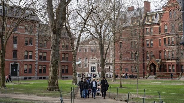 (FILES) People walk through Harvard Yard on the Harvard University campus in Cambridge, Massachusetts, on April 15, 2025. US President Donald Trump's administration on Thursday revoked Harvard's right to enroll foreign students -- more than a quarter of its annual enrollment -- in a major escalation of the president's fight with one of the world's most storied universities. Trump is furious at Harvard -- which has produced 162 Nobel prize winners -- for rejecting his demand that it submit to oversight on admissions and hiring over his claims that it is a hotbed of anti-Semitism and 