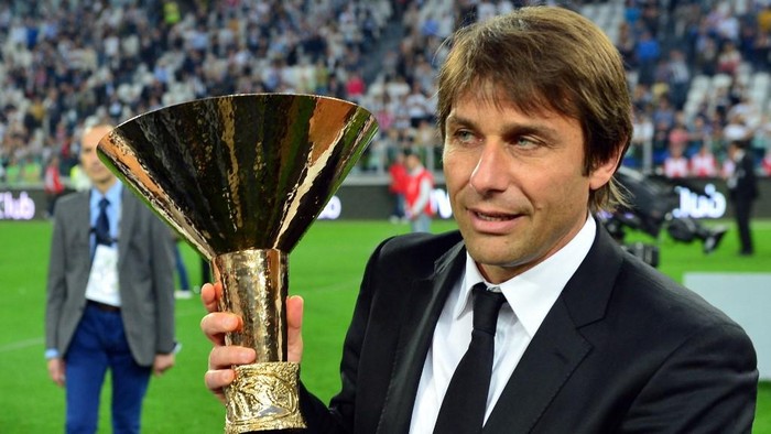 Juventus coach Antonio Conte celebrates with the trophy during the ceremony of the Scudetto, the Italian Serie A trophy after the Italian Serie A football match between Juventus and Cagliari at the 