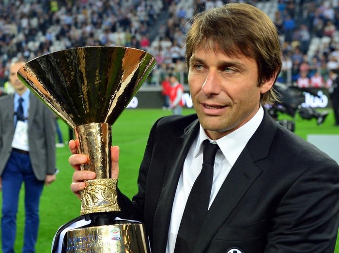 Juventus' coach Antonio Conte celebrates with the trophy during the ceremony of the Scudetto, the Italian Serie A trophy after the Italian Serie A football match between Juventus and Cagliari at the 