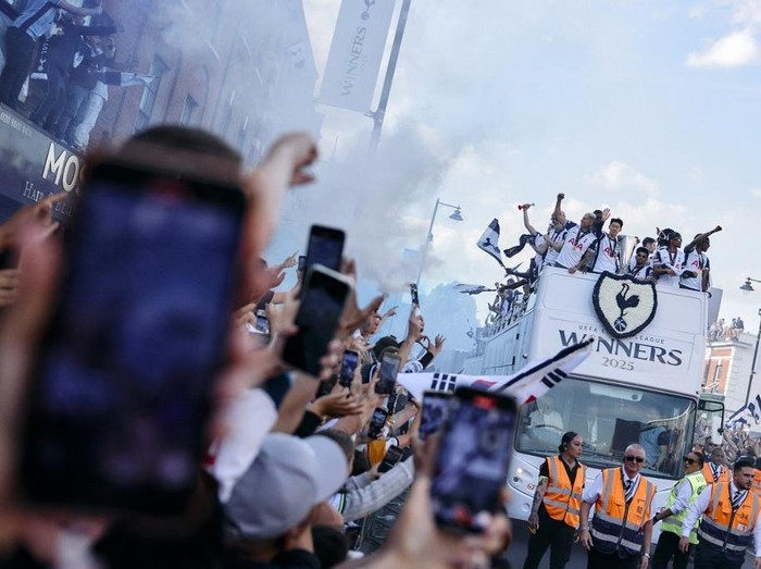 Tottenham Hotspur's players, including Tottenham Hotspur's Brazilian forward #09 Richarlison and Tottenham Hotspur's South Korean forward #07 Son Heung-Min show off the Europa League trophy during an open-top bus parade through the streets of north London on May 23, to celebrate their win over Manchester United in the UEFA Europa League final football match in Bilbao on May 21, 2025. (Photo by BENJAMIN CREMEL / AFP)