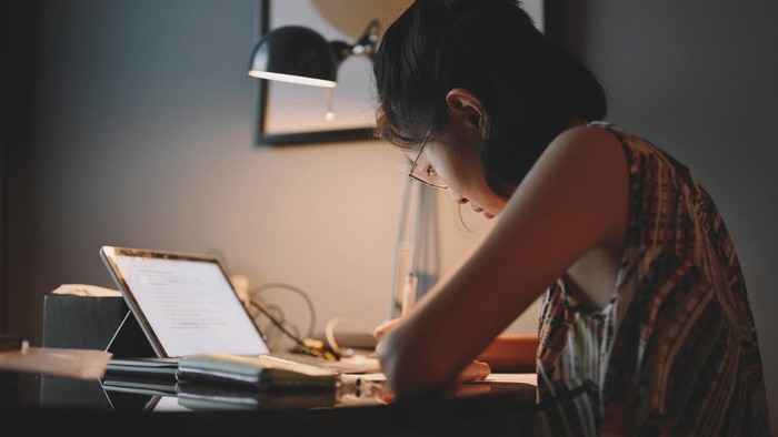 Teenager study education online learning / self study concept. Collage girl do reseaching and  internet online. night time