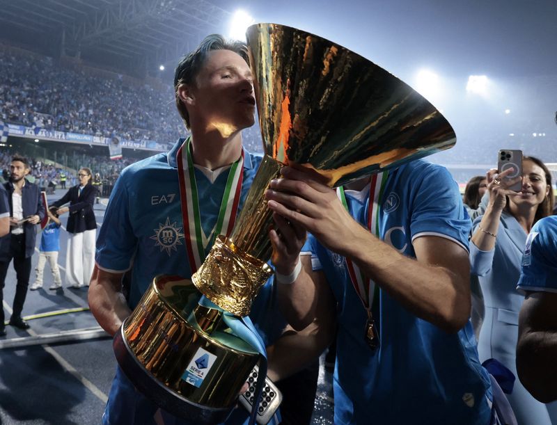 Soccer Football - Serie A - Napoli v Cagliari - Stadio Diego Armando Maradona, Naples, Italy - May 24, 2025 Napoli's Scott McTominay kisses the trophy as he celebrates winning Serie A REUTERS/Remo Casilli