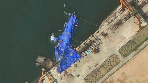 This handout satellite image courtesy of Maxar Technologies taken on May 23, 2025, shows a general view of a new North Korean warship at the harbor after its launch accident in Chongjin. North Korea has begun an investigation into the accident that occurred during the May 21, 2025, launch, state media said on May 23, 2025, assessing the damage as 