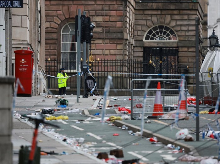 Forensic officers work near the site of an incident where a car plowed into a crowd of Liverpool fans during a parade celebrating their side's Premier League soccer title, in central Liverpool, Britain, May 27, 2025. REUTERS/Phil Noble