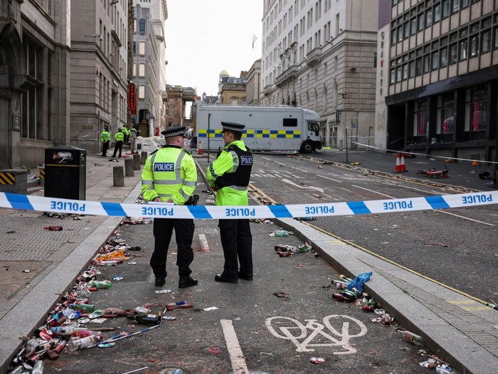 Forensic officers work near the site of an incident where a car plowed into a crowd of Liverpool fans during a parade celebrating their side's Premier League soccer title, in central Liverpool, Britain, May 27, 2025. REUTERS/Phil Noble