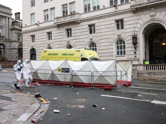 Forensic officers work near the site of an incident where a car plowed into a crowd of Liverpool fans during a parade celebrating their side's Premier League soccer title, in central Liverpool, Britain, May 27, 2025. REUTERS/Phil Noble