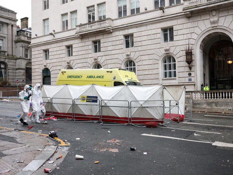 Forensic officers work near the site of an incident where a car plowed into a crowd of Liverpool fans during a parade celebrating their side's Premier League soccer title, in central Liverpool, Britain, May 27, 2025. REUTERS/Phil Noble