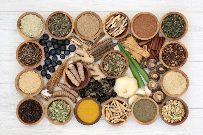 Adaptogen health food with herbs, spices, fruit & supplement powders. Natural plant based foods that help the body deal with frustasi & promote or restore wajar  physiological functions. On rustic wood.