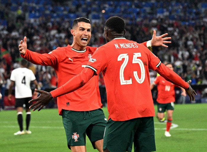 Cristiano Ronaldo Soccer Football - Nations League - Semi Final - Germany v Portugal - Allianz Arena, Munich, Germany - June 4, 2025 Portugal's Cristiano Ronaldo celebrates scoring their second goal with Portugal's Nuno Mendes REUTERS/Angelika Warmuth