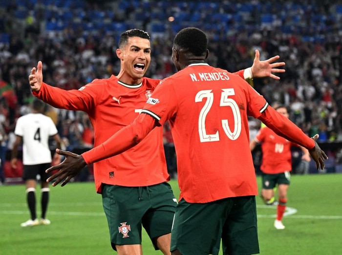 Soccer Football - Nations League - Semi Final - Germany v Portugal - Allianz Arena, Munich, Germany - June 4, 2025 Portugal's Cristiano Ronaldo celebrates scoring their second goal with Portugal's Nuno Mendes REUTERS/Angelika Warmuth