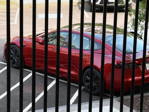 A Tesla vehicle purchased by U.S. President Donald Trump earlier this year is parked in West Executive Avenue, between the White House and the Eisenhower Executive Office Building, in Washington, D.C., U.S., June 6, 2025. REUTERS/Kevin Lamarque