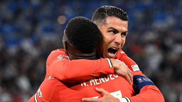 Cristiano Ronaldo Soccer Football - Nations League - Semi Final - Germany v Portugal - Allianz Arena, Munich, Germany - June 4, 2025 Portugals Cristiano Ronaldo celebrates scoring their second goal with Portugals Nuno Mendes REUTERS/Angelika Warmuth